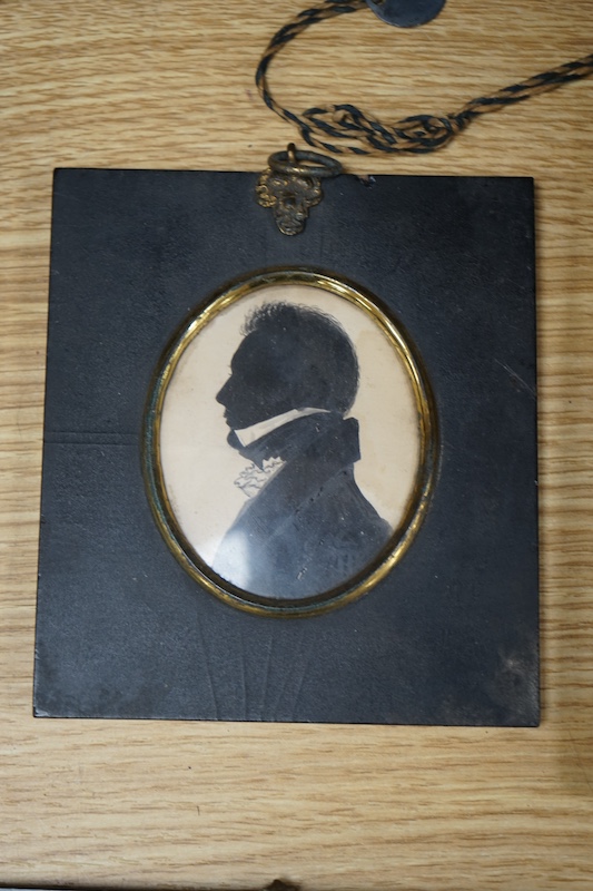 A family group of five 19th century silhouettes in ebony frames, largest 9cm high. Condition - fair